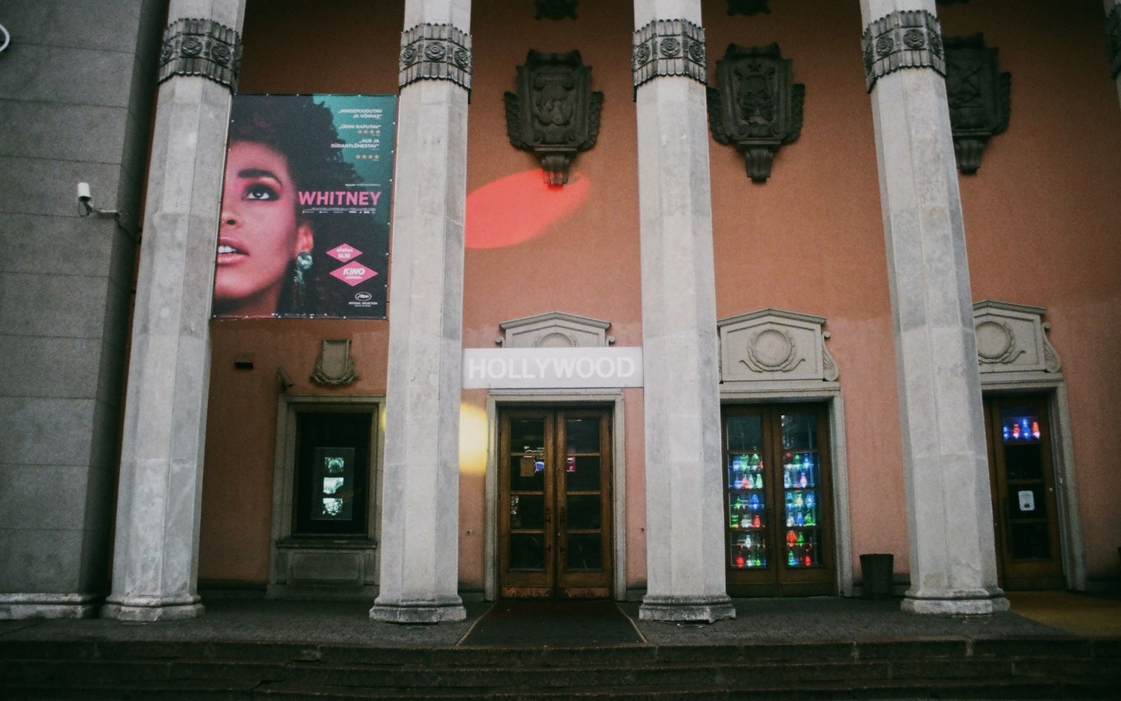 A cinema façade with a documentary poster mounted above the entrance